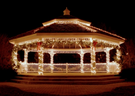 A picture of a gazebo lit up in lights